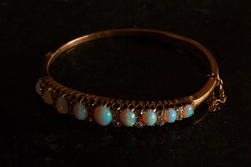 Lot 38 - A Victorian opal and diamond hinged bangle,...