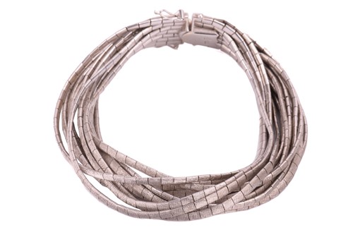 Lot 197 - A thirteen-row omega link bracelet, with cross-...