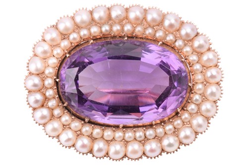 Lot 127 - A Victorian amethyst and pearl brooch, centred...