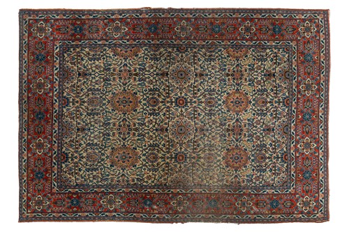 Lot 24 - An antique ivory ground Kerman rug with an...