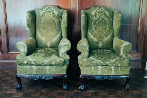 Lot 35 - A pair of George III style upholstered wing...
