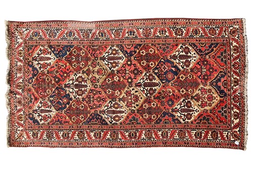 Lot 165 - A red ground Baktiari carpet, with an allover...