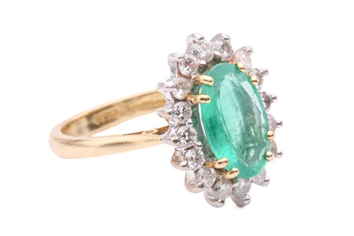 Lot 51 - An emerald and diamond cluster ring, the oval...