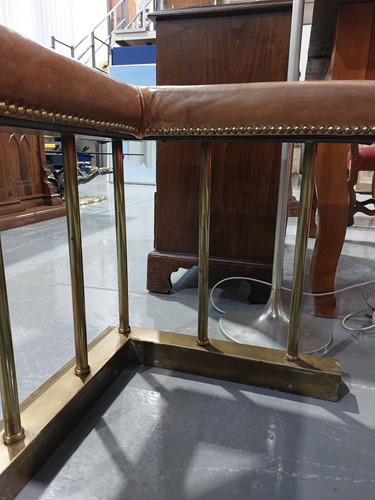 Lot 197 - A brass club fender, with leather covered seat...