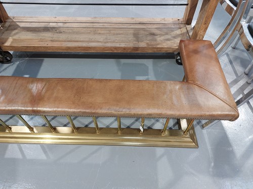 Lot 197 - A brass club fender, with leather covered seat...