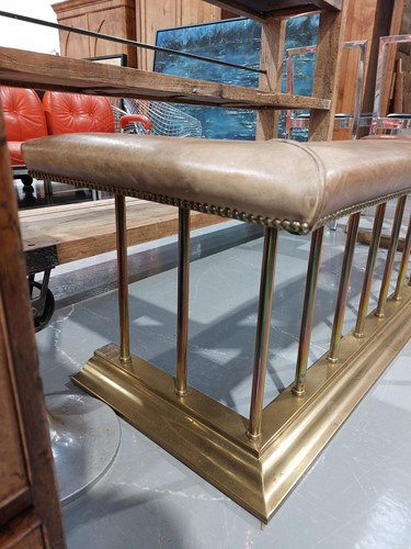 Lot 197 - A brass club fender, with leather covered seat...