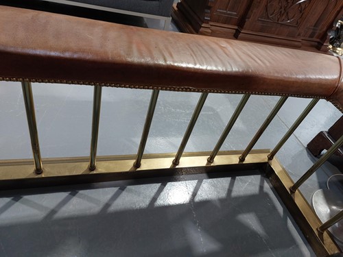 Lot 197 - A brass club fender, with leather covered seat...