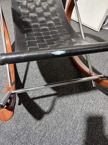 Lot 290 - A black leather 'Donna' Rocking chair by Elio...