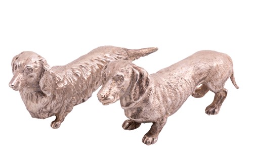 Lot 478 - A cast silver model of a wire-coated dachshund;...