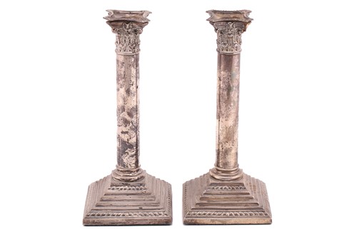 Lot 414 - A pair of column candlesticks, with Corinthian...