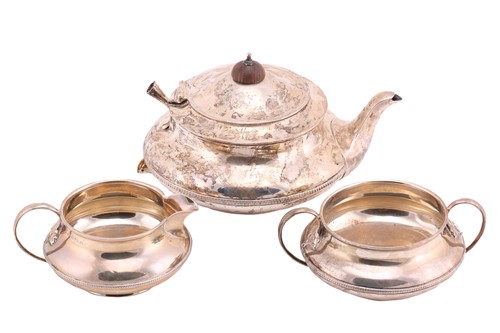 Lot 445 - A three-piece silver tea set; circular with...