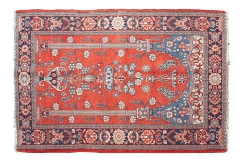 Lot 211 - An old red ground Kashan rug with twin pillar...