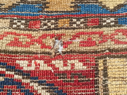 Lot 180 - An antique red ground Shirvan carpet with five...