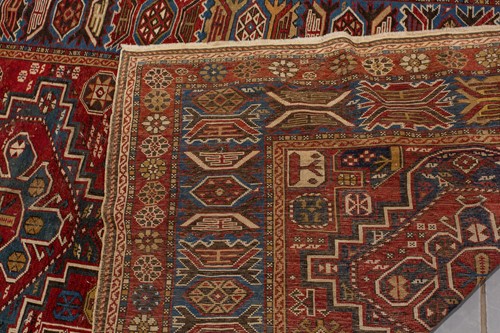 Lot 180 - An antique red ground Shirvan carpet with five...