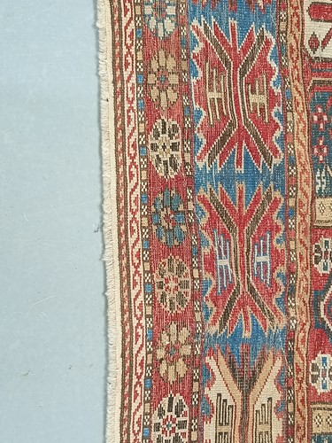 Lot 180 - An antique red ground Shirvan carpet with five...
