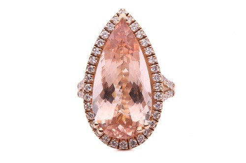 Lot 228 - A morganite and diamond halo ring, featuring a...