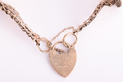 Lot 111 - A tapering gate bracelet with a heart-shaped...