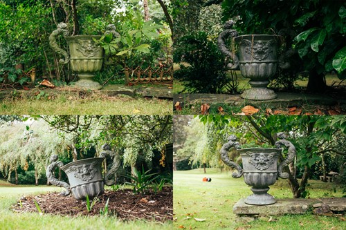 Lot 185 - A set of four twin-handled lead garden urns,...