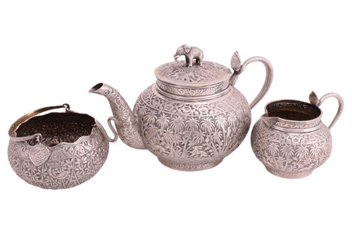 Lot 449 - A white metal Burmese three piece tea set, the...