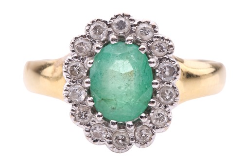 Lot 101 - An emerald and diamond cluster ring; the oval...