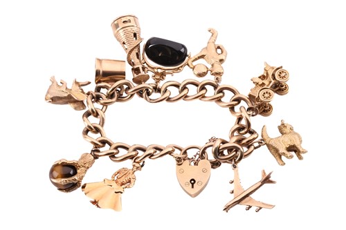 Lot 324 - A charm bracelet, the gate bracelet with...