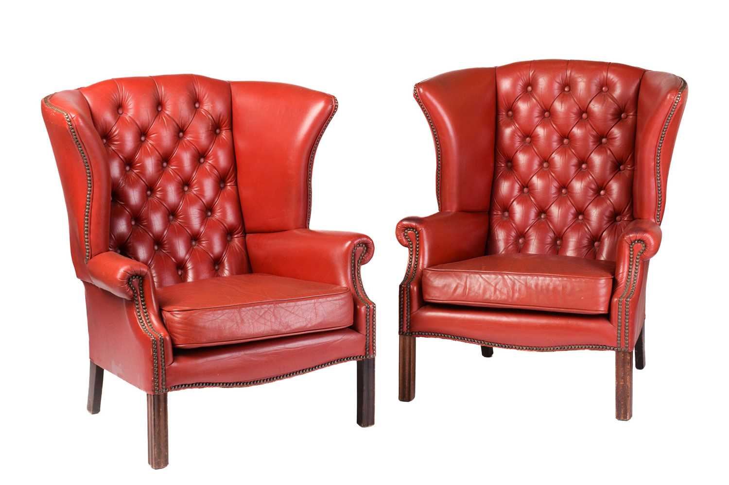 Lot 172 - A pair of red leather button back wing...