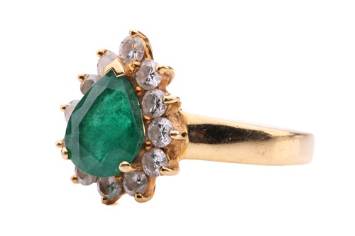 Lot 80 - An emerald and diamond cluster ring, the...