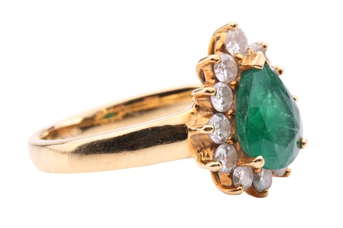 Lot 80 - An emerald and diamond cluster ring, the...