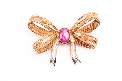 Lot 315 - A star ruby and diamond bow brooch by Geoffrey...