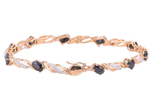 Lot 313 - A sapphire and diamond line bracelet in 9ct...