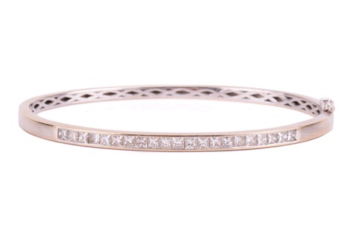 Lot 216 - A diamond-set hinged bracelet in 18ct white...