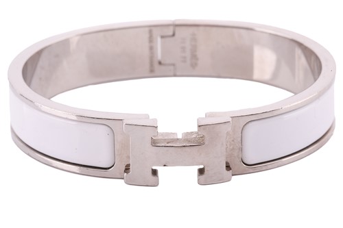 Lot 149 - A Clic H bracelet with white enamel by Hermés...