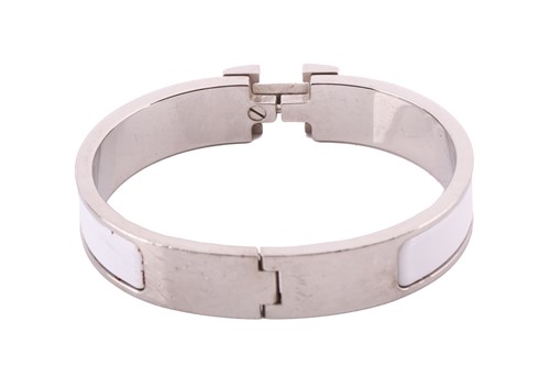 Lot 149 - A Clic H bracelet with white enamel by Hermés...