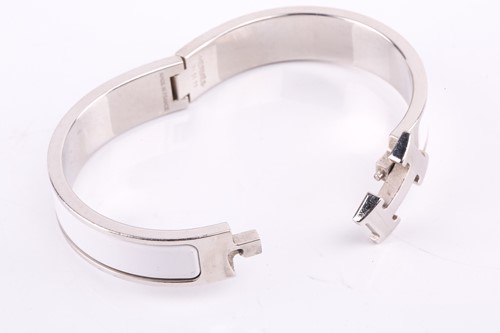 Lot 149 - A Clic H bracelet with white enamel by Hermés...