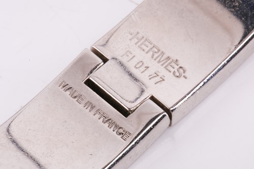 Lot 149 - A Clic H bracelet with white enamel by Hermés...
