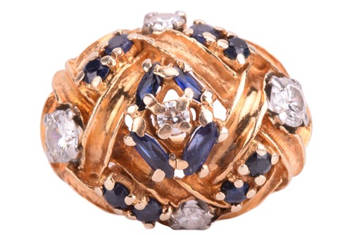 Lot 330 - A diamond and sapphire dress ring, in a bombé...