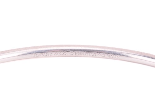 Lot 80 - Tiffany & Co. - a silver open bangle, with the...