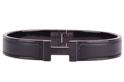 Lot 287 - Hermès - a narrow 'Clic HH So Black' bracelet...