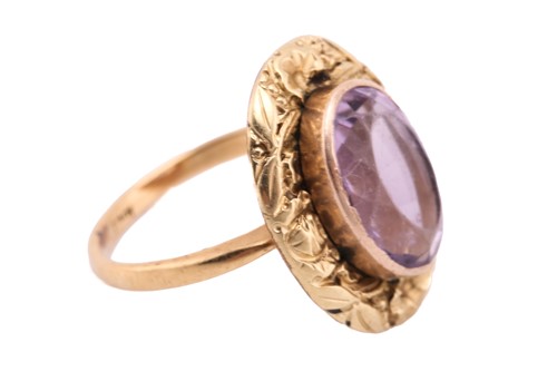 Lot 28 - An amethyst dress ring, comprising an oval-cut...