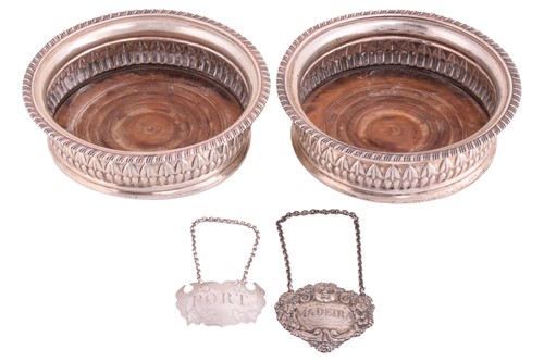 Lot 428 - A pair of George III silver wine coasters,...