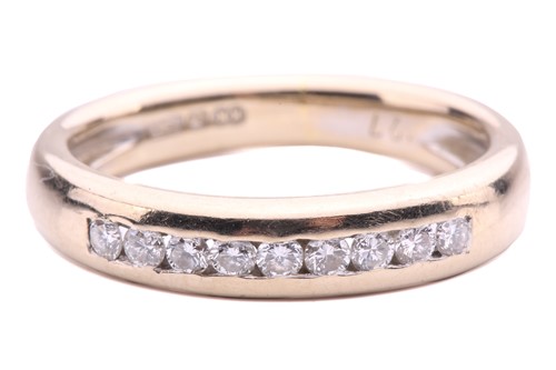 Lot 109 - A diamond nine stone half hoop ring, set with...