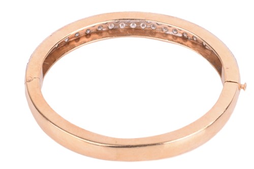 Lot 45 - A diamond-set hinged bracelet, consisting of...