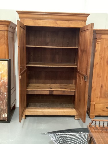 Lot 154 - A 19th century Continental maple armoire, the...