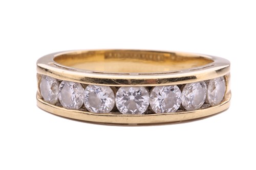 Lot 64 - A seven-stone half-hoop diamond ring, channel...