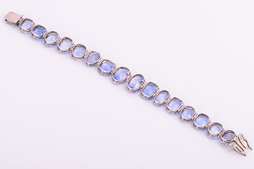 Lot 98 - A Ceylon sapphire bracelet, set with a row of...