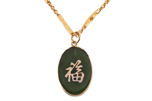 Lot 285 - A Chinese jade pendant on high carat bar link...