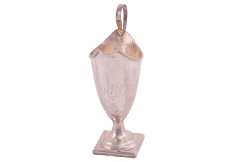 Lot 209 - A George III silver helmet cream jug with a...
