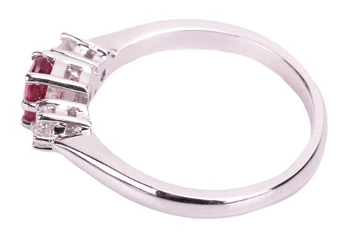 Lot 15 - A ruby and diamond trilogy ring in 18ct white...