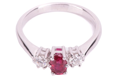 Lot 15 - A ruby and diamond trilogy ring in 18ct white...
