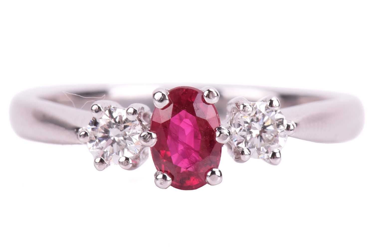 Lot 15 - A ruby and diamond trilogy ring in 18ct white...